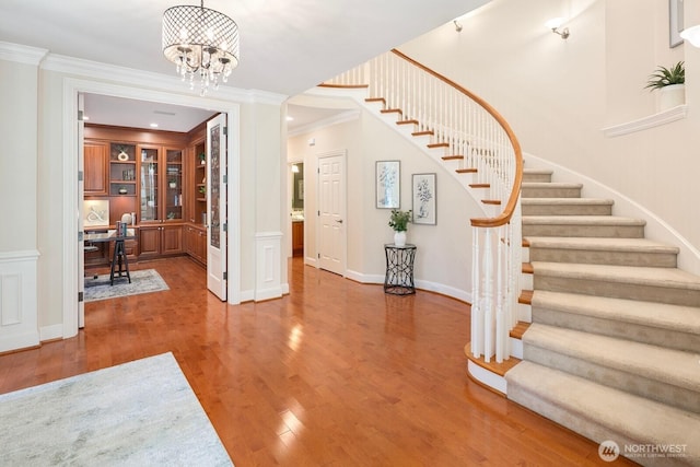 13695 NE 32nd Pl, Bellevue, WA 98005 - entrance foyer featuring crown molding, stairs, wood finished floors, and a chandelier