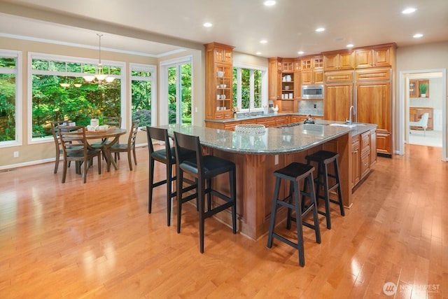 13695 NE 32nd Pl, Bellevue, WA 98005 - kitchen with stainless steel microwave, open shelves, plenty of natural light, a spacious island, and recessed lighting