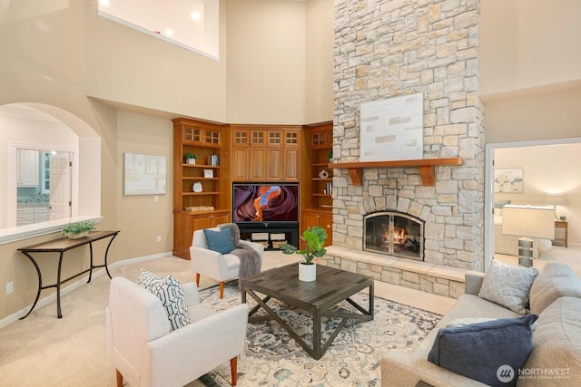 13695 NE 32nd Pl, Bellevue, WA 98005 - living room featuring a towering ceiling, a fireplace, light carpet, and arched walkways