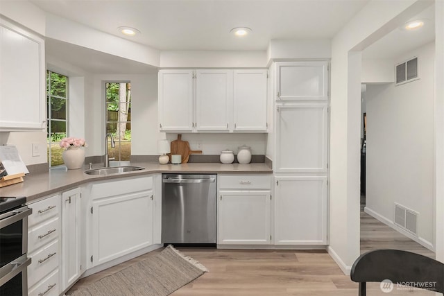 8527 134th Ct NE, Redmond, WA 98052 - kitchen with appliances with stainless steel finishes, white cabinets, light wood-type flooring, recessed lighting, and light countertops