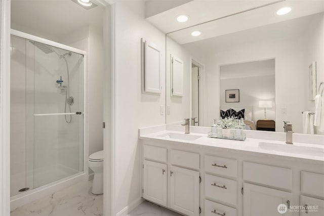8527 134th Ct NE, Redmond, WA 98052 - ensuite bathroom with marble finish flooring, a shower stall, double vanity, and recessed lighting