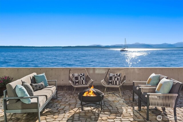 7117 Beach Dr SW, Seattle, WA 98136 - view of patio / terrace with an outdoor living space with a fire pit and a water and mountain view