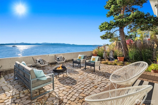 7117 Beach Dr SW, Seattle, WA 98136 - view of patio / terrace featuring an outdoor living space with a fire pit and a water and mountain view