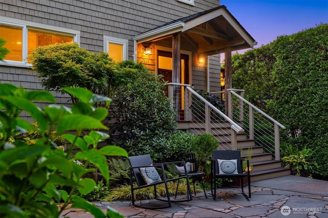 7117 Beach Dr SW, Seattle, WA 98136 - exterior entry at dusk with a patio