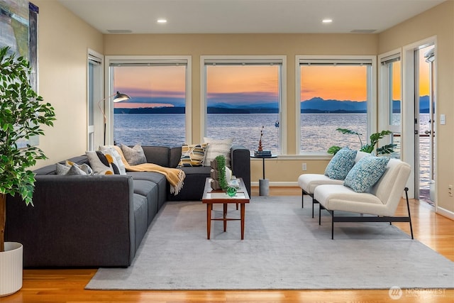 7117 Beach Dr SW, Seattle, WA 98136 - living room with wood finished floors, recessed lighting, and a water view