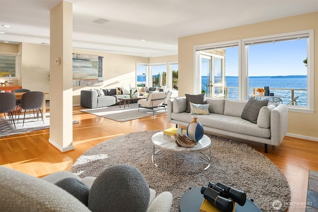 7117 Beach Dr SW, Seattle, WA 98136 - living room featuring plenty of natural light, wood finished floors, recessed lighting, and a water view