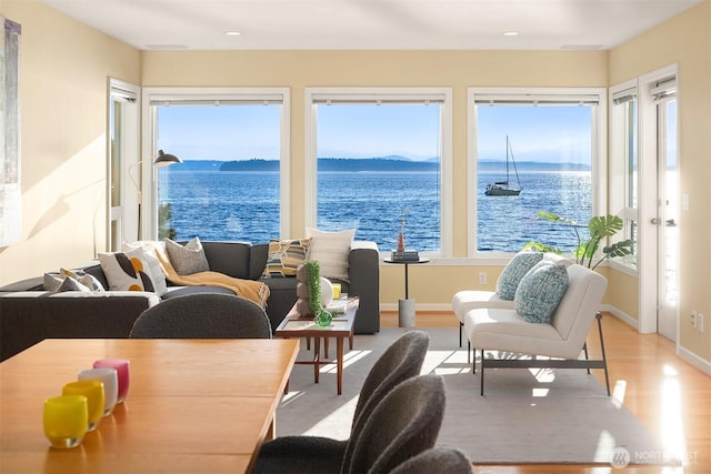 7117 Beach Dr SW, Seattle, WA 98136 - living room with wood finished floors, healthy amount of natural light, a water view, and recessed lighting