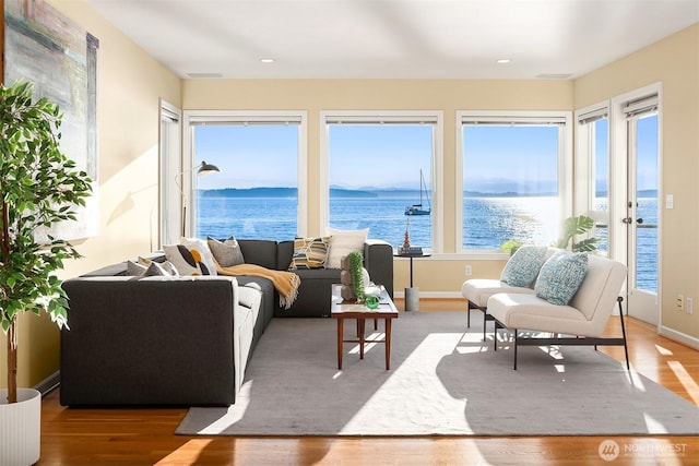 7117 Beach Dr SW, Seattle, WA 98136 - living room featuring a water view, light wood-style floors, and recessed lighting