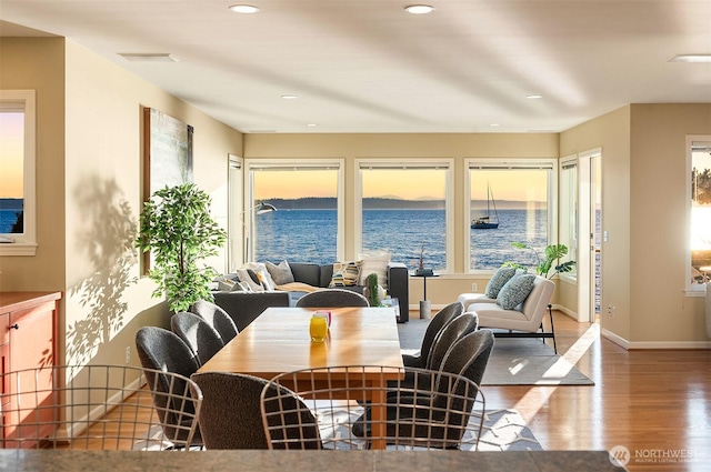 7117 Beach Dr SW, Seattle, WA 98136 - dining room featuring wood finished floors, recessed lighting, and a water view
