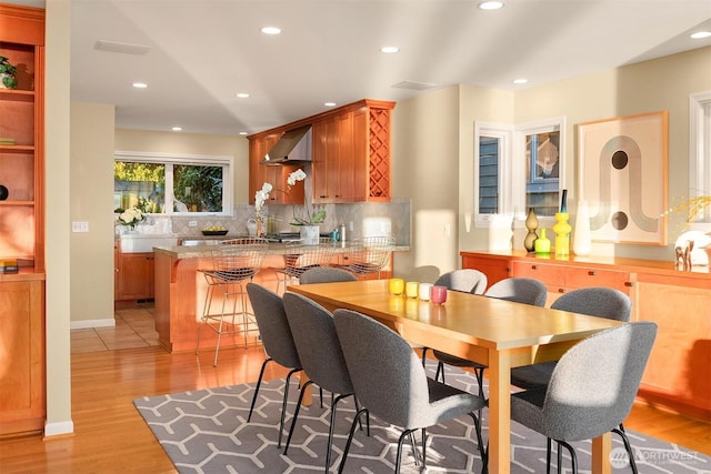 7117 Beach Dr SW, Seattle, WA 98136 - dining room featuring light wood-style floors, recessed lighting, and wet bar