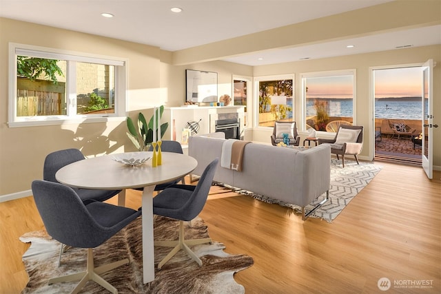 7117 Beach Dr SW, Seattle, WA 98136 - dining room featuring a tile fireplace, light wood-style floors, and recessed lighting