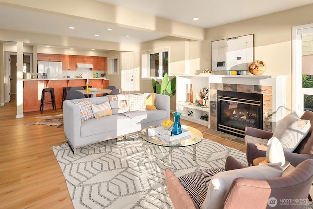 7117 Beach Dr SW, Seattle, WA 98136 - living room featuring light wood-style floors, a tile fireplace, and recessed lighting