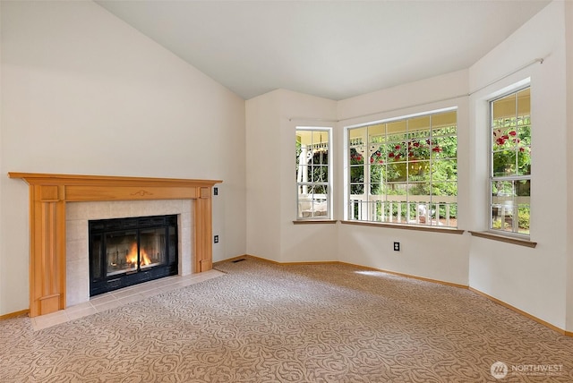 14013 116th Ave E, Puyallup, WA 98374 - unfurnished living room featuring a fireplace, carpet floors, and lofted ceiling