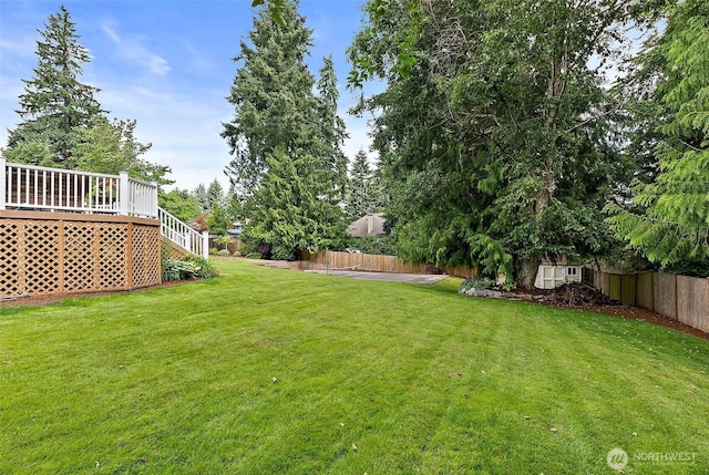 14013 116th Ave E, Puyallup, WA 98374 - fenced backyard featuring a wooden deck and stairway