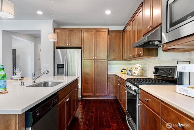 4529 185th Pl SE, Bothell, WA 98012 - kitchen with appliances with stainless steel finishes, under cabinet range hood, dark wood-style flooring, light countertops, and recessed lighting
