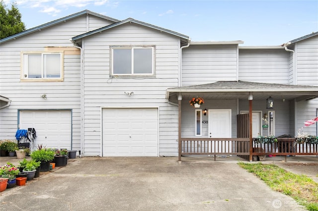 438 Washington Blvd Unit 3, Algona, WA 98001 - view of property featuring an attached garage, concrete driveway, and covered porch