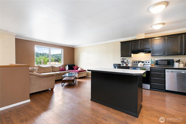 438 Washington Blvd Unit 3, Algona, WA 98001 - kitchen with stainless steel appliances, under cabinet range hood, a center island, crown molding, and wood finished floors