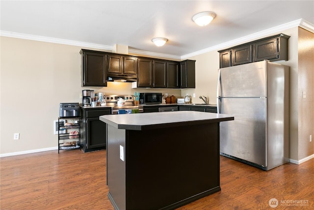 438 Washington Blvd Unit 3, Algona, WA 98001 - kitchen with stainless steel appliances, under cabinet range hood, a center island, dark wood-style flooring, and ornamental molding