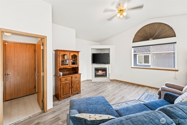 1346 Chatham Dr SE, Olympia, WA 98513 - living room featuring vaulted ceiling, ceiling fan, light wood-style flooring, and a fireplace