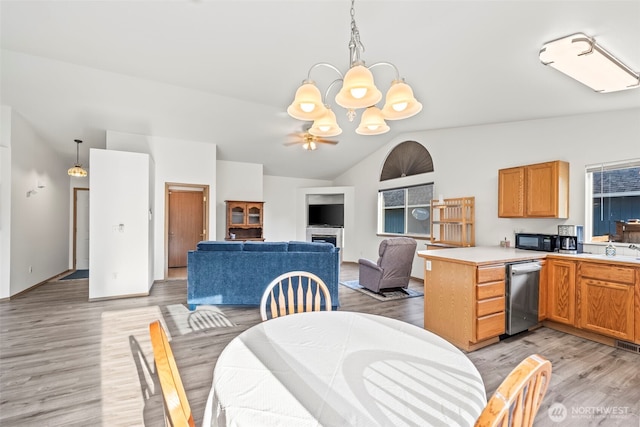1346 Chatham Dr SE, Olympia, WA 98513 - dining area featuring a chandelier, light wood finished floors, vaulted ceiling, and a ceiling fan