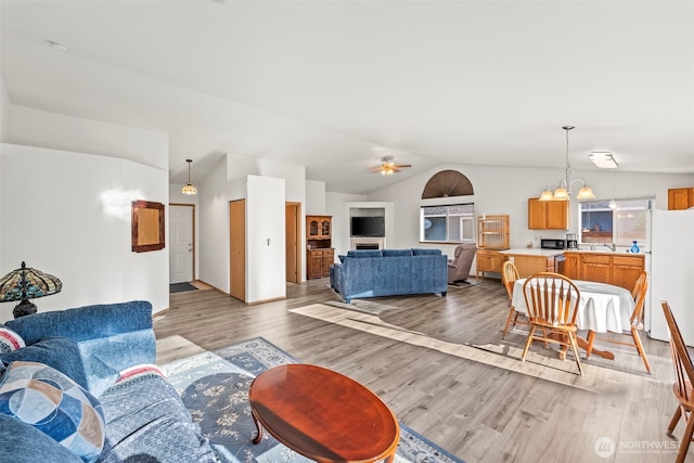 1346 Chatham Dr SE, Olympia, WA 98513 - living room featuring light wood-style flooring, lofted ceiling, a chandelier, and ceiling fan