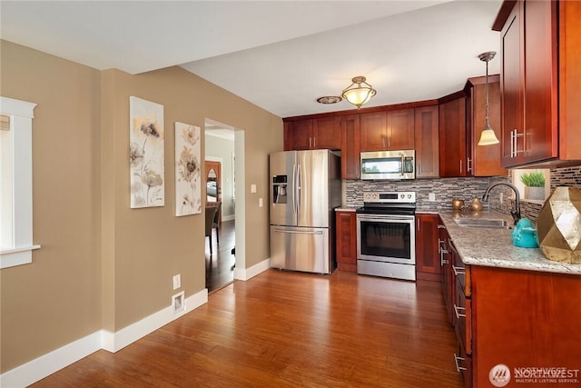 6208 Fremont Ave N, Seattle, WA 98103 - kitchen with appliances with stainless steel finishes, decorative backsplash, dark wood finished floors, and light stone counters