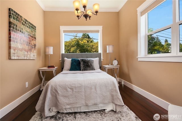 6208 Fremont Ave N, Seattle, WA 98103 - bedroom with a chandelier, multiple windows, dark wood finished floors, and ornamental molding