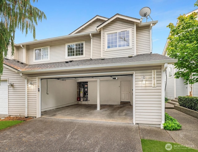 17515 110th Ln SE Unit 27, Renton, WA 98055 - view of front of house with an attached garage, asphalt driveway, and secured water heater