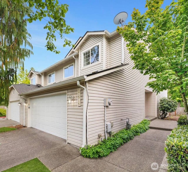17515 110th Ln SE Unit 27, Renton, WA 98055 - view of property exterior featuring a garage and asphalt driveway