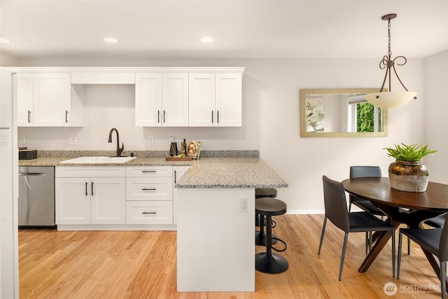 17515 110th Ln SE Unit 27, Renton, WA 98055 - kitchen featuring dishwasher, white cabinetry, a breakfast bar area, light wood-style flooring, and recessed lighting