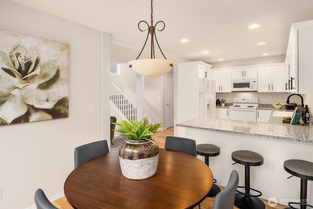 17515 110th Ln SE Unit 27, Renton, WA 98055 - dining area featuring stairs, recessed lighting, and light wood-style flooring