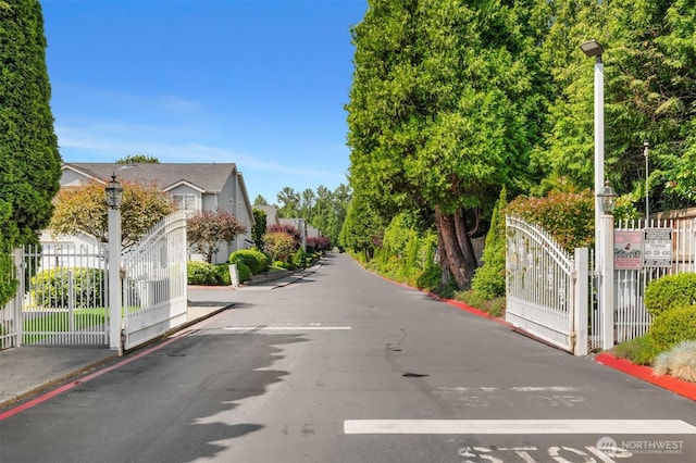 17515 110th Ln SE Unit 27, Renton, WA 98055 - view of asphalt road featuring street lighting and a gate