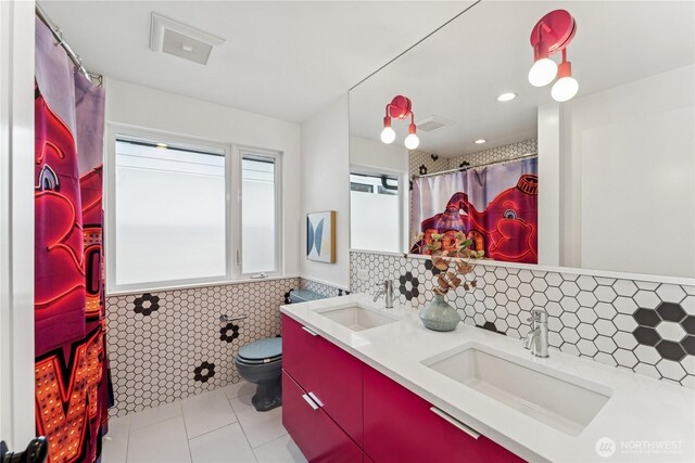 2626 W Lynn St, Seattle, WA 98199 - full bath with double vanity, tile patterned floors, recessed lighting, a shower with shower curtain, and wainscoting