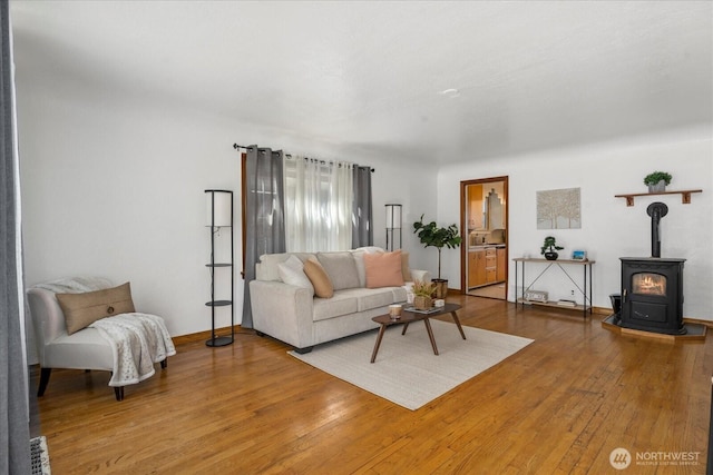 7012 S Warner St, Tacoma, WA 98409 - living room featuring light wood-style floors and a wood stove