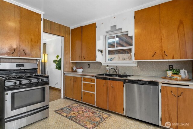 7012 S Warner St, Tacoma, WA 98409 - kitchen with appliances with stainless steel finishes, tasteful backsplash, brown cabinetry, and light countertops