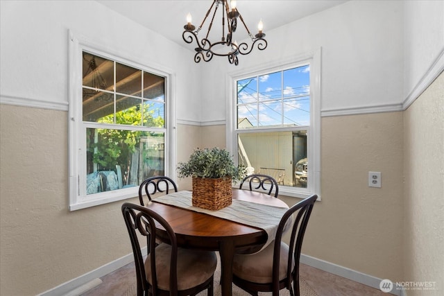 7012 S Warner St, Tacoma, WA 98409 - dining space featuring a chandelier and a textured wall
