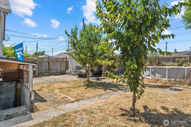 7012 S Warner St, Tacoma, WA 98409 - fenced backyard featuring a patio