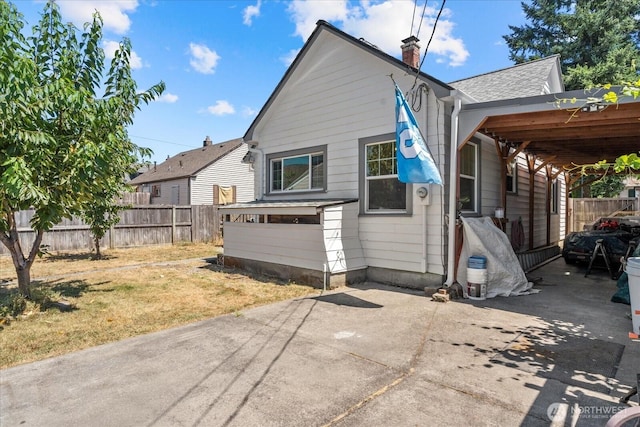 7012 S Warner St, Tacoma, WA 98409 - rear view of house featuring a chimney and a shingled roof