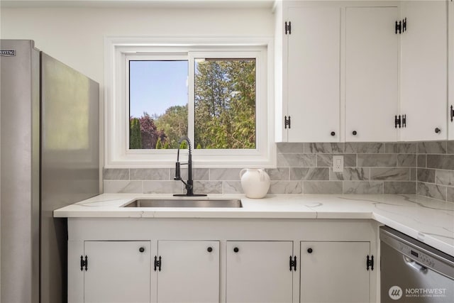 1626 127th Ave NE, Lake Stevens, WA 98258 - kitchen featuring appliances with stainless steel finishes, backsplash, white cabinetry, and light stone countertops