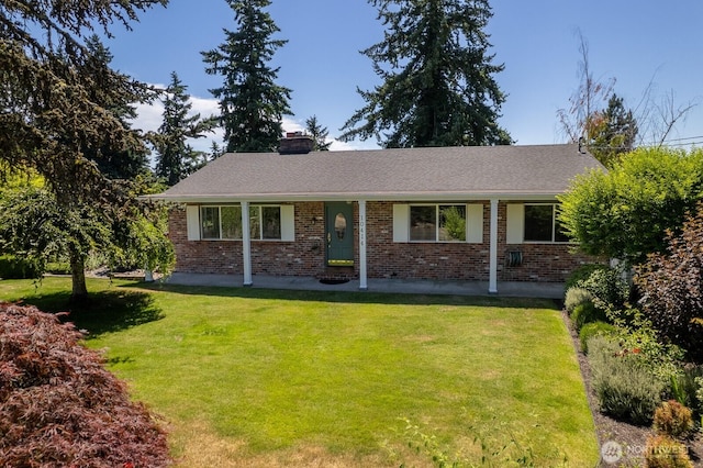 10414 43rd Street Ct E, Edgewood, WA 98372 - view of front of home with brick siding, a front yard, and a chimney