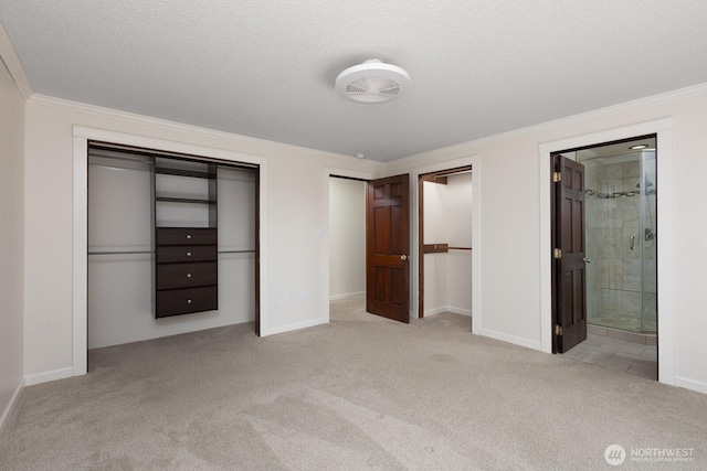 10414 43rd Street Ct E, Edgewood, WA 98372 - unfurnished bedroom with multiple closets, carpet, crown molding, and connected bathroom