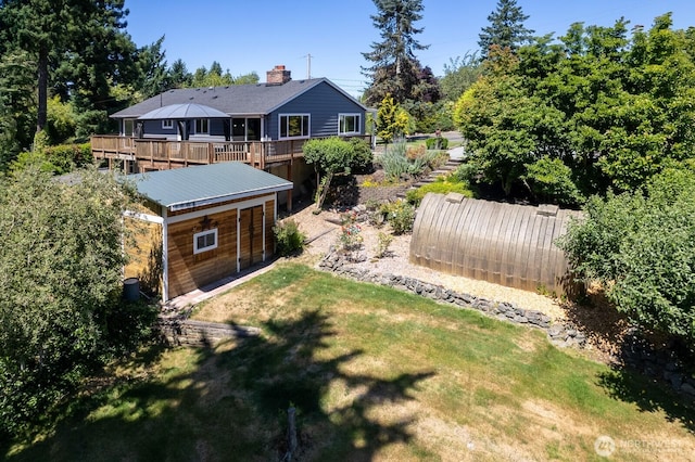10414 43rd Street Ct E, Edgewood, WA 98372 - view of green lawn featuring a deck and an outdoor structure
