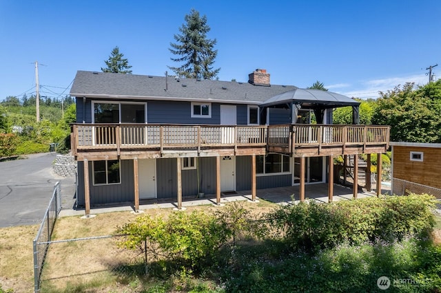 10414 43rd Street Ct E, Edgewood, WA 98372 - back of house with a chimney, a deck, a gazebo, and a patio