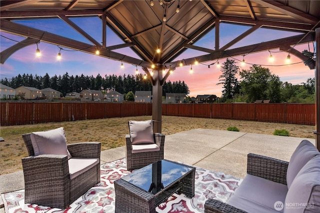 22817 80th Avenue Ct E, Graham, WA 98338 - patio terrace at dusk with a patio, a fenced backyard, and a gazebo