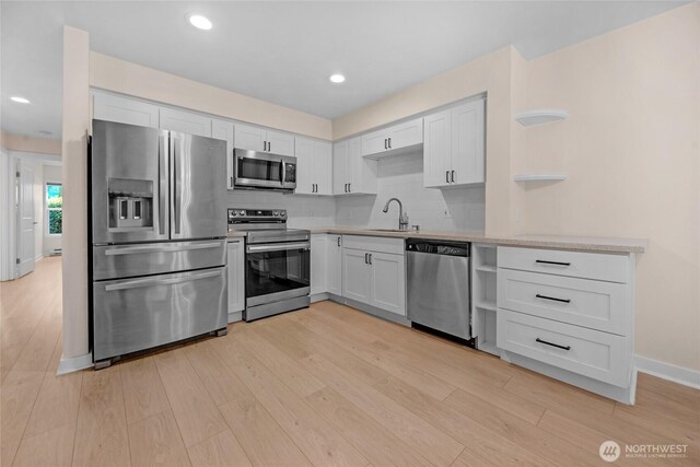 12303 Harbour Pointe Blvd Unit S104, Mukilteo, WA 98275 - kitchen with stainless steel appliances, open shelves, light countertops, light wood-style flooring, and recessed lighting