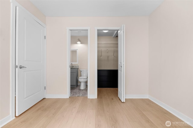 12303 Harbour Pointe Blvd Unit S104, Mukilteo, WA 98275 - unfurnished bedroom featuring light wood-style flooring, a spacious closet, a closet, and ensuite bathroom