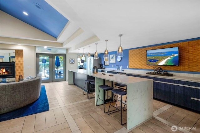 12303 Harbour Pointe Blvd Unit S104, Mukilteo, WA 98275 - kitchen featuring french doors, a kitchen breakfast bar, light countertops, decorative light fixtures, and open floor plan