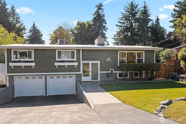 2120 Seaview St W, University Place, WA 98466 - split foyer home featuring a chimney, an attached garage, concrete driveway, and a front yard