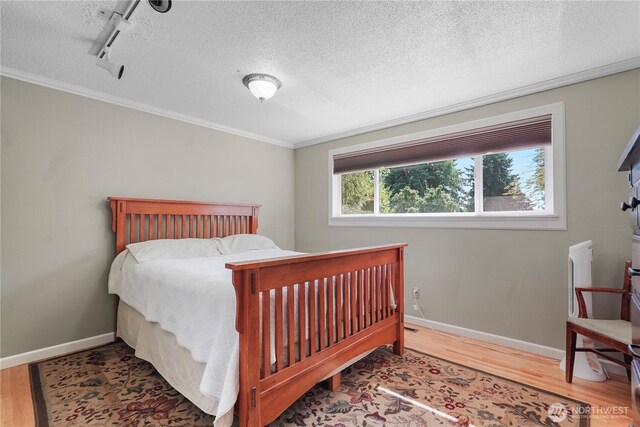 2120 Seaview St W, University Place, WA 98466 - bedroom featuring wood finished floors, track lighting, crown molding, and a textured ceiling