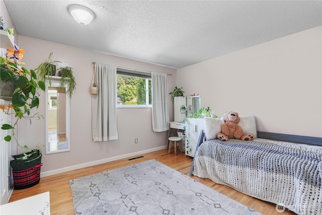 2120 Seaview St W, University Place, WA 98466 - bedroom with wood finished floors and a textured ceiling